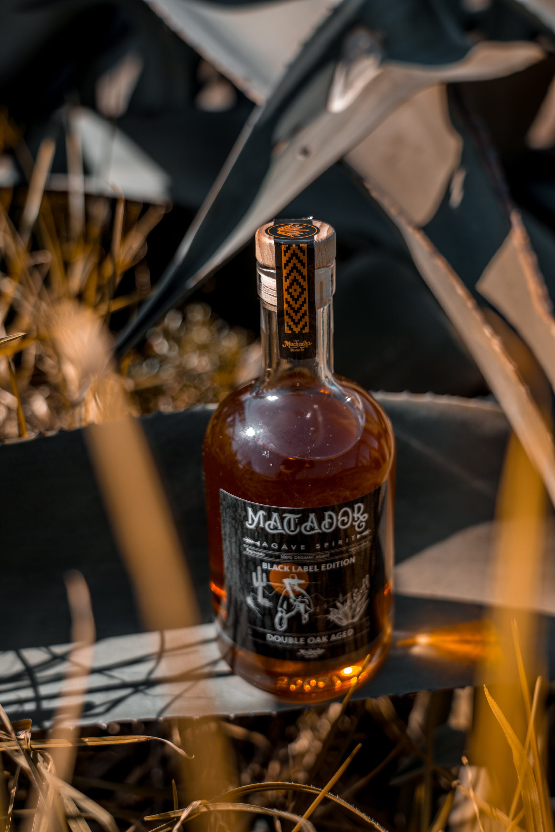 Bottle of Matador Black Label tequila  anejo with a blurred natural background