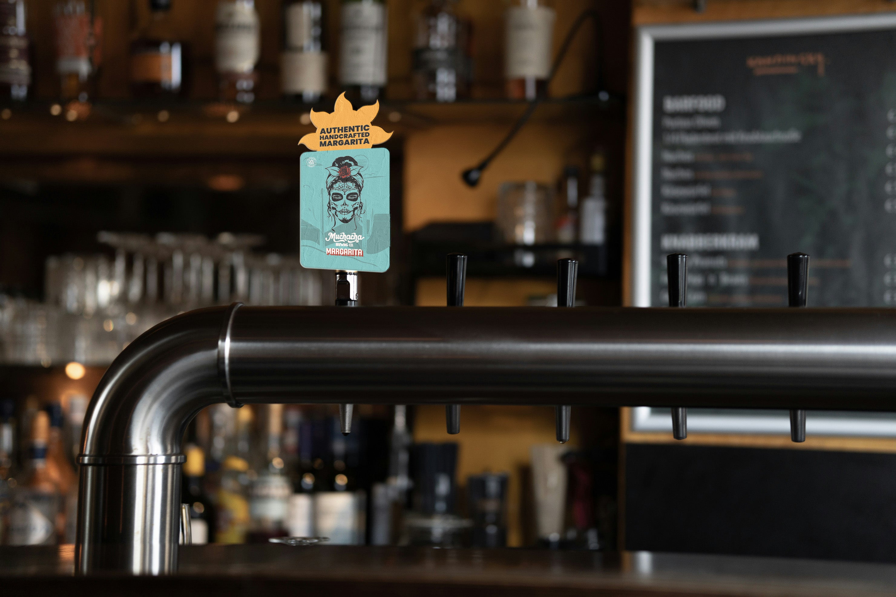 Margis on tap with a branded sign in a bar setting